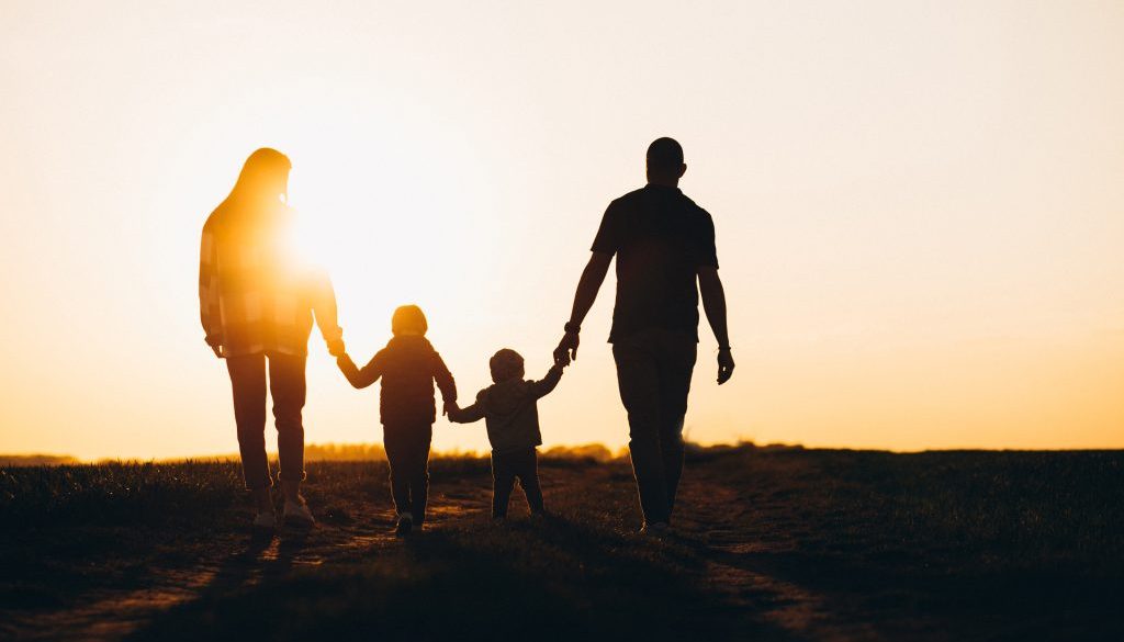 Happy family silhouette on the sunset